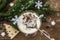 Traditional prune dessert with walnuts and whipped sour cream with sugar. New Year`s sweet treat concept. Wooden boards backgroun