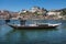 Traditional Rabelo Boat on the Bank of the River Douro and Colorful Facades of Typical Houses- Porto, Portugal