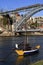 Traditional rabelo boats, Porto city skyline, Douro river and and Dom Luis or Luiz iron bridge. Porto