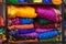 Traditional Rajasthan dress materials for sale in a cloth merchant shop in India. Colorful Jodhpur fabric street stall. Bandhej or