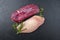 Traditional raw gourmet duck breast filet with skin with herbs and pepper on a black board