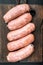 Traditional raw pork sausages, flat lay, on black background