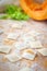 Traditional raw ravioli with pumpkin on a wooden table with flour