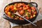 Traditional recipe for chili sweet potatoes and black beans with tomatoes, celery close-up in a pan. horizontal