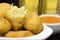 Traditional recipe codfish balls in a pub table with one open in close