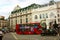 The traditional red double-decker London buses in the traffic on the streets of Soho