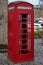 Traditional red english phone booth facing right