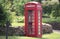 Traditional red English phone box ina country lane