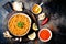 Traditional red lentil Dal. Indian Dhal spicy curry in bowl with flat bread and spices. Top view, overhead.