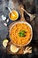 Traditional red lentil Dal. Indian Dhal spicy curry in bowl with flat bread and spices. Top view, overhead.