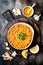 Traditional red lentil Dal. Indian Dhal spicy curry in bowl with flat bread and spices. Top view, overhead.