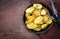 Traditional roast Potatoes with herbs in an iron cast pan