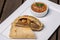 Traditional roasted Argentinian empanadas with meat filling against wooden background