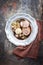 Traditional rolled boar roast with bread dumpling, fried chicory and mushroom as top view on a pewter plate