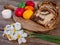 Traditional romanian easter dish cozonac or sweetbread on wooden table and colored easter eggs