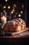Traditional Romanian sweet bread against a rustic wooden plate. Christmas bokeh lights background.