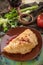 Traditional russian and caucasian meat pie cheburek with pomegranate deep fried on wooden table