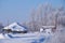 Traditional russian country house izba in village Talitsa under winter snow