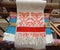 Traditional russian folk handmade red thread embroidery at natural white linen