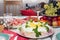 Traditional Russian salad herring under a fur coat on a large white dish decorated with greens and eggs with red caviar