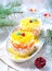 Traditional Russian salad Mimosa with salmon, potatoes, cheese, carrots and eggs.