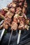 Traditional Russian shashlik on a barbecue skewer with roasted onion on metal tray