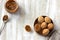 Traditional Russian  shortbread nuts with boiled condensed milk, sprinkled with powdered sugar in a wooden bowl on a wooden