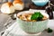 Traditional Russian soup-Rassolnik with pickled cucumber, barley, chicken, tomatoes and parsley in ceramic bowl. Selective focus