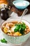 Traditional Russian soup-Rassolnik with pickled cucumber, barley, chicken, tomatoes and parsley in ceramic bowl. Selective focus