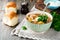 Traditional Russian soup-Rassolnik with pickled cucumber, barley, chicken, tomatoes and parsley in ceramic bowl. Selective focus