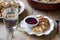 Traditional Russian syrniki with raisins. Sweet quark pancakes with blueberry sauce