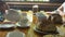 Traditional russian tea party. a table served with tea cups, teapots, on the table rolls with poppy seeds pancakes, jam