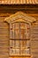 Traditional russian wooden window with closed shatters in warm tones