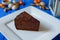 Traditional sacher cake sliced on white squared plate