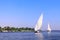 Traditional sailing boat felucca, Nile river, Aswan, Egypt. A famous tourist attraction - sailing boat ride