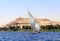 Traditional sailing boat felucca, Nile river near Aswan, Egypt. Famous tourist attraction - sailing boat ride