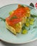 Traditional salmon puff pastry with fresh grapes. Delicious recipe. Served on a plate over traditional tablecloth