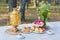 Traditional samovar on a table with snacks and field flowers bouquet outdoor