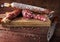 Traditional sausage and sausage with mold. Sliced sausage salami and  knife on wooden board with spices.