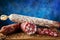 Traditional sausage and sausage with mold. Sliced sausage salami on wooden board with spices. Close-up