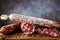 Traditional sausage and sausage with mold. Sliced sausage salami on wooden board with spices. Close-up