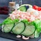 Traditional savory swedish sandwich cake Smorgastorta with bread, shrimps, eggs, caviar, dill, mayonnaise, cucumber and lettuce,