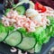 Traditional savory swedish sandwich cake Smorgastorta with a bread, shrimps, eggs, caviar, dill, mayonnaise, cucumber and lettuce