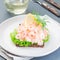 Traditional savory swedish sandwich with a dark bread, lettuce, eggs, mayonnaise, shrimps, dill and lemon, square