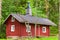 Traditional Scandinavian red wooden house in forest