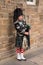 Traditional Scottish bagpiper wearing kilt