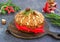 A traditional Scottish Christmas fruit Dundee cake with a mix of dried fruits, decorated with peeled almonds on a wooden board on