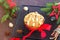 A traditional Scottish Christmas fruit mini Dundee cake with a mix of dried fruits, decorated with peeled almonds, on a black wire