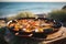 Traditional seafood paella in the pan on a table by the sea