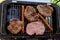 Traditional serbian barbecue rostilj  homemade sausages and burgers. Preparing a barbecue on a grill, outdoor roasting meat. Tra